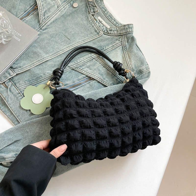 New checkered pleated women's bag with vibrant floral accessories for commuting