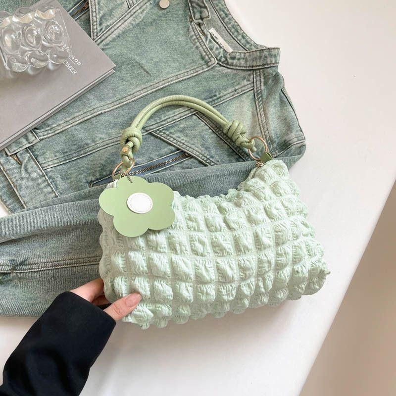 New checkered pleated women's bag with vibrant floral accessories for commuting